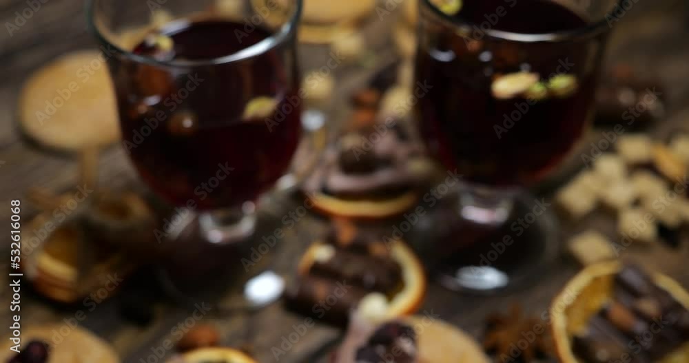 Mulled wine with cookies, chocolate, orange slices and other sweets on the background of an old vintage wooden board. Mulled wine with cookies, chocolate, orange slices and other sweets on the background of an old vintage wooden board.