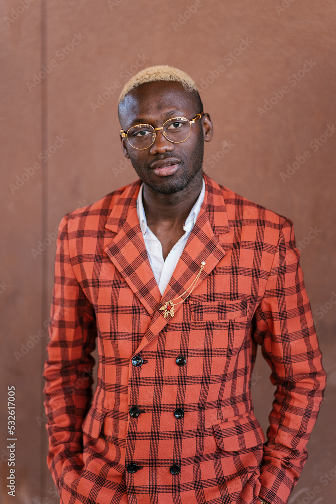 Fashionable black guy in trendy suit looking at camera Fashionable black guy in trendy suit looking at camera