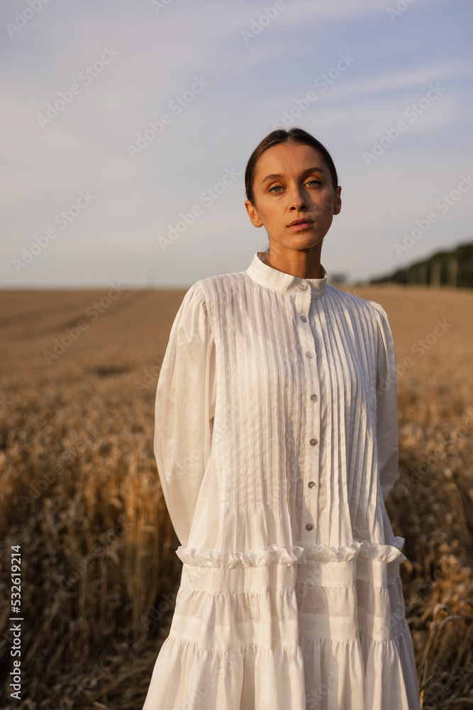 Girl in linen dress looking at camera Girl in linen dress looking at camera