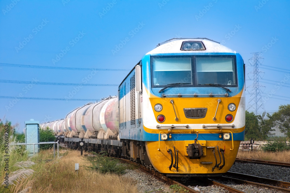 Obraz premium Tanker-freight train by diesel locomotive on the railway.