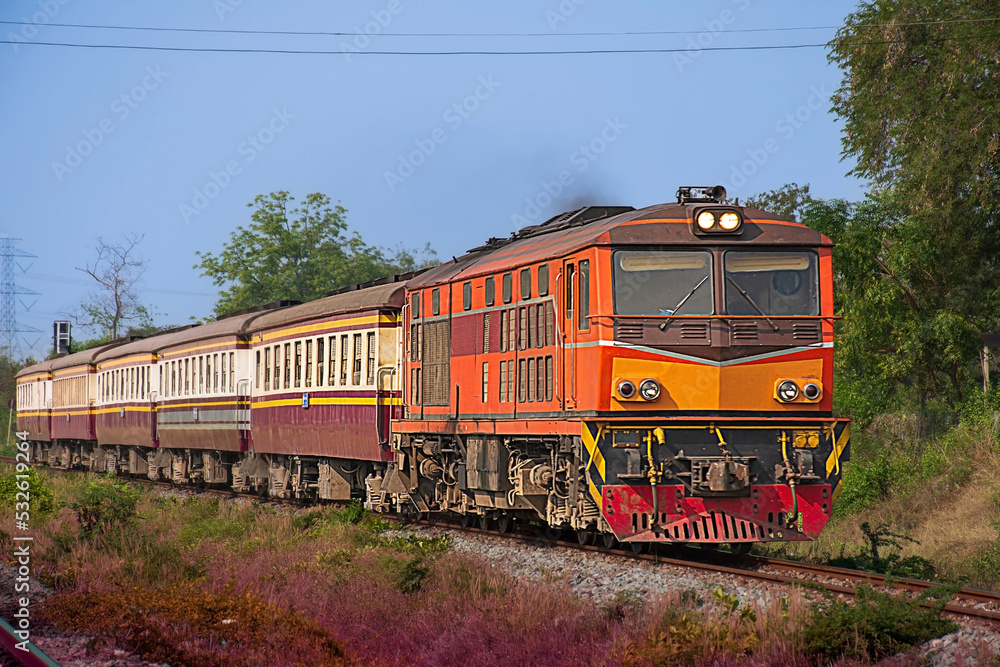 Fototapeta premium Passenger train by diesel locomotive on the railway.