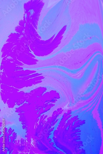 Abstract lilac marble background. Acrylic paint spreads freely and creates an interesting pattern. Background for the cover of a laptop, notebook.