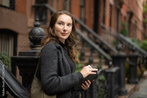 Woman in front of apartment buildings