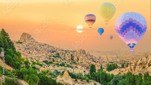 hot air balloons over Goreme town in Cappadocia Turkey during sunrisie