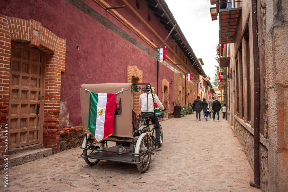 Obraz premium Valquirico, Tlaxcala, Mexico, 09 17 22, Tourist cart runs along the street of Valquirico during Mexican celebrations on a cloudy day