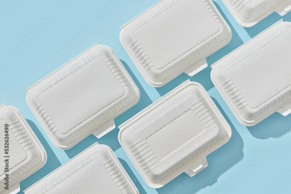 Disposable lunch boxes in two rows. Stock Photo Adobe Stock