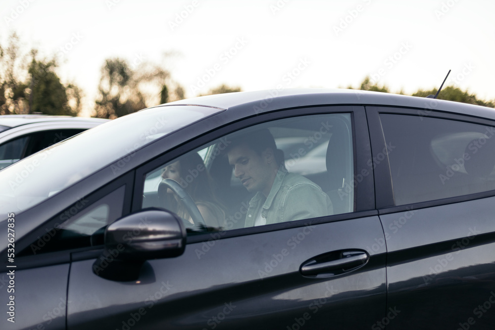 Couple watching a movie on a drive-in cinema Couple watching a movie on a drive-in cinema