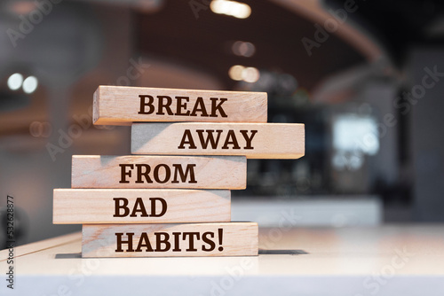 Wooden blocks with words 'break away from bad habits'.