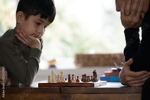 Little kid playing chess photo