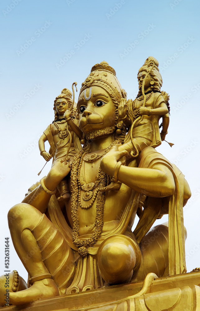 Indian Hindu god Hanuman carrying Rama and Lakshmana on shoulders statue in a temple