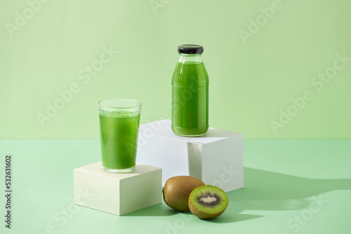 Natural kiwi juice in glass and bottle. photo