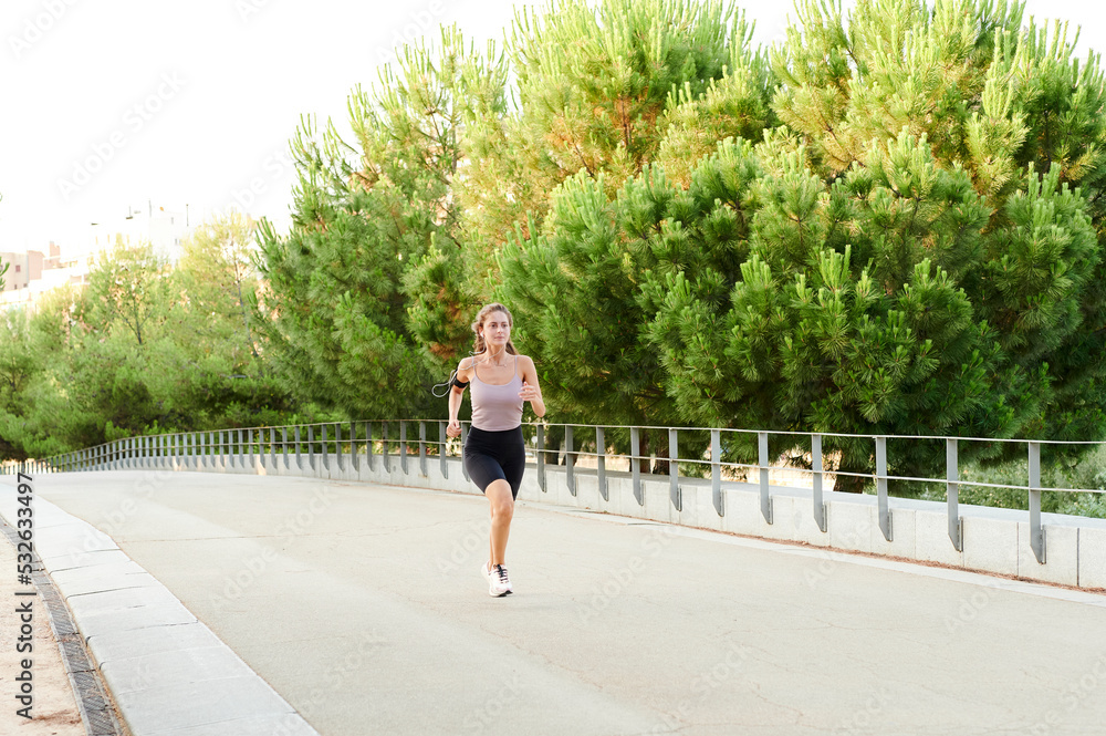 Woman jogging along a road Woman jogging along a road