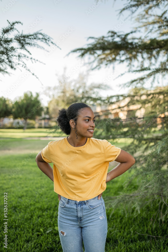 portrait of a black teenage girl next to a pine tree outdoors portrait of a black teenage girl next to a pine tree outdoors