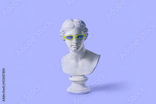 Plaster Venus bust in fashionable sunglasses. photo