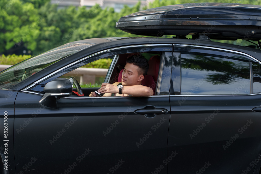 man resting and smoking beside the car man resting and smoking beside the car