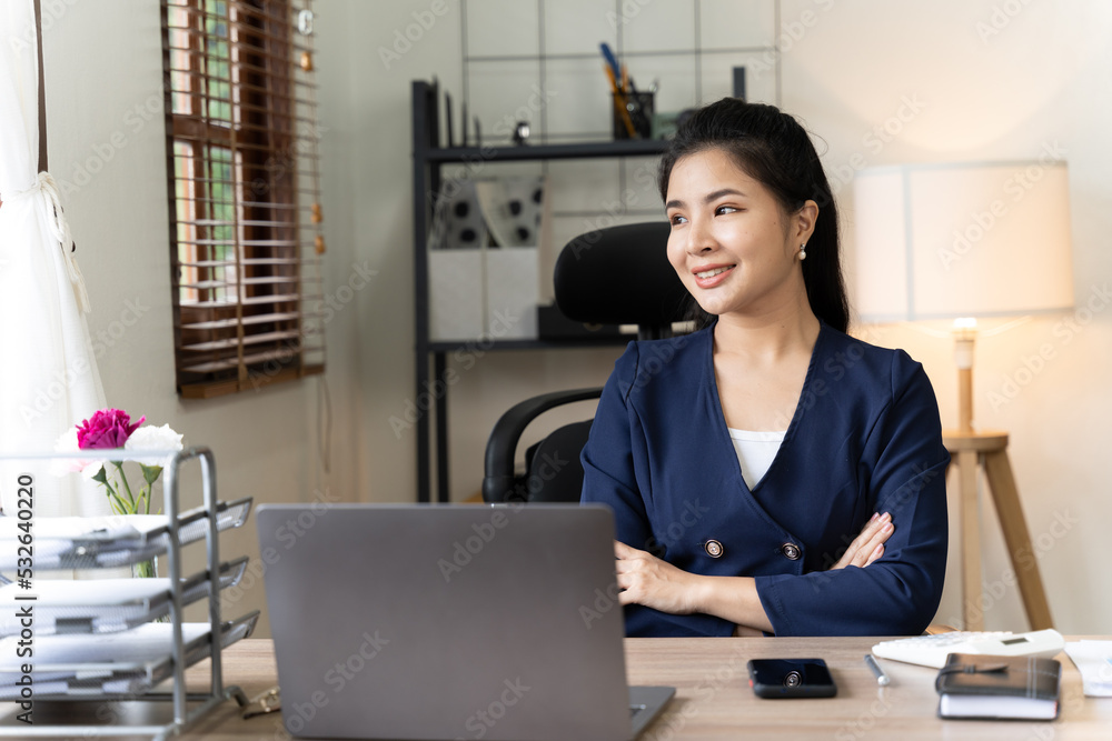 Asian woman working with laptop in her office. business financial concept. Asian woman working with laptop in her office. business financial concept.