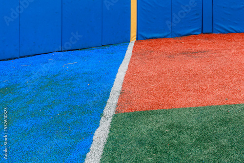 Blue, red, and green ballpark floor close-up. photo
