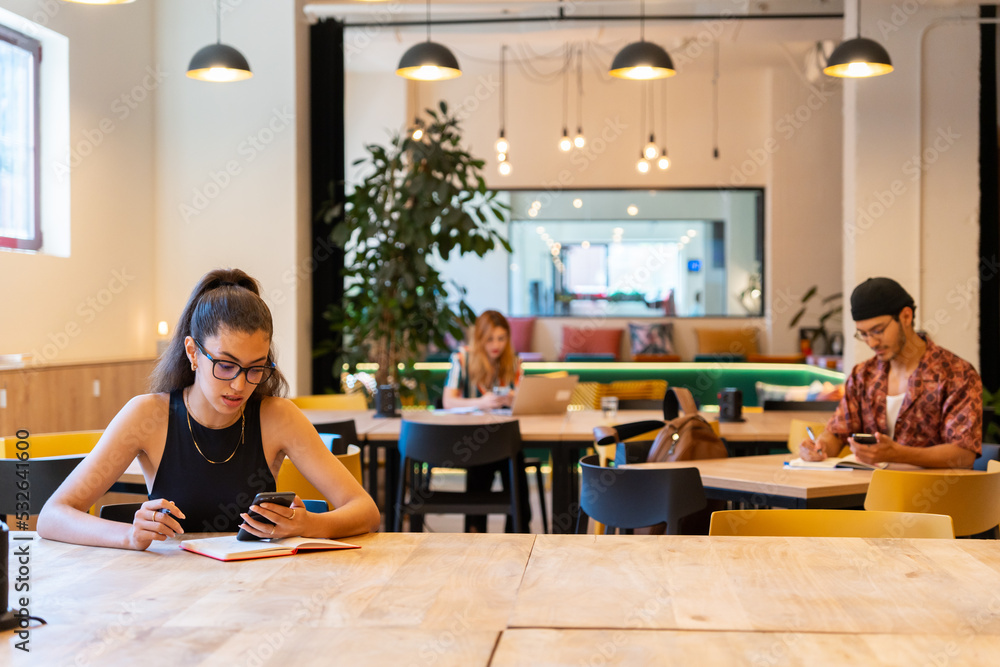© Luis Velasco/Stocksy - Brunette Woman Working In The Office. © Luis Velasco/Stocksy - Brunette Woman Working In The Office.