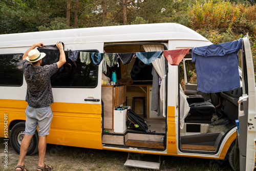 Man hanging the laundry outdoors photo