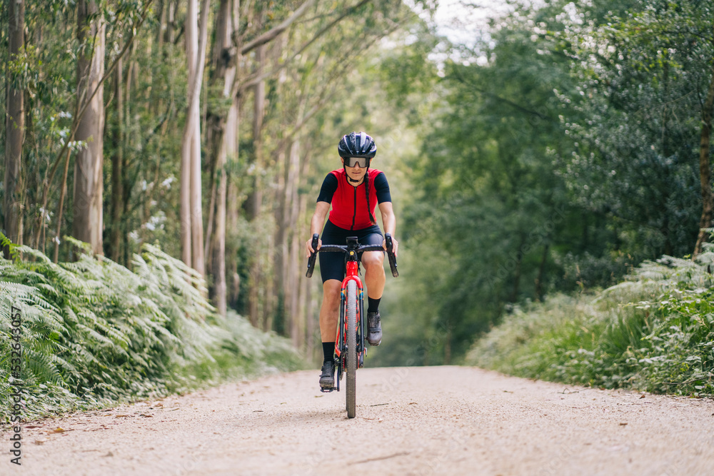 Cyclist riding gravel bike on road Cyclist riding gravel bike on road