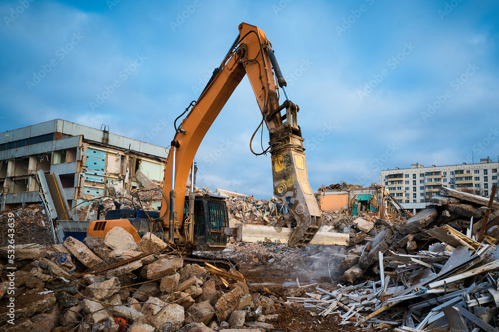 Excavator with hydraulic scissors cuts reinforced concrete Excavator with hydraulic scissors cuts reinforced concrete