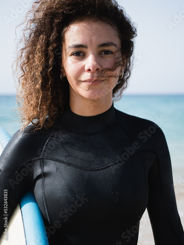 Pretty young multiracial surfer female with afro hair portrait © 1 MEDIA