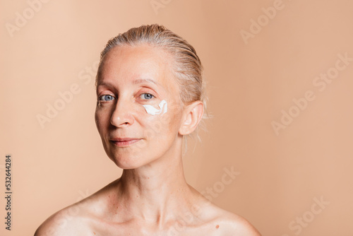 Moisturizing and delivering anti-aging benefits of dermatology cream photo