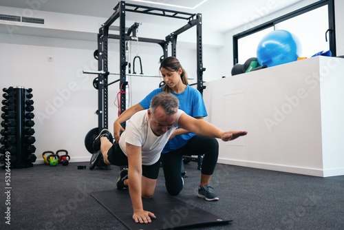 Man doing yoga in a physiotherapy clinic photo