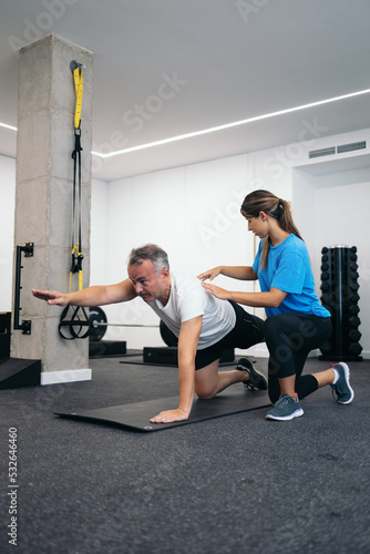 Man doing rehabilitation exercises with his physical therapist photo