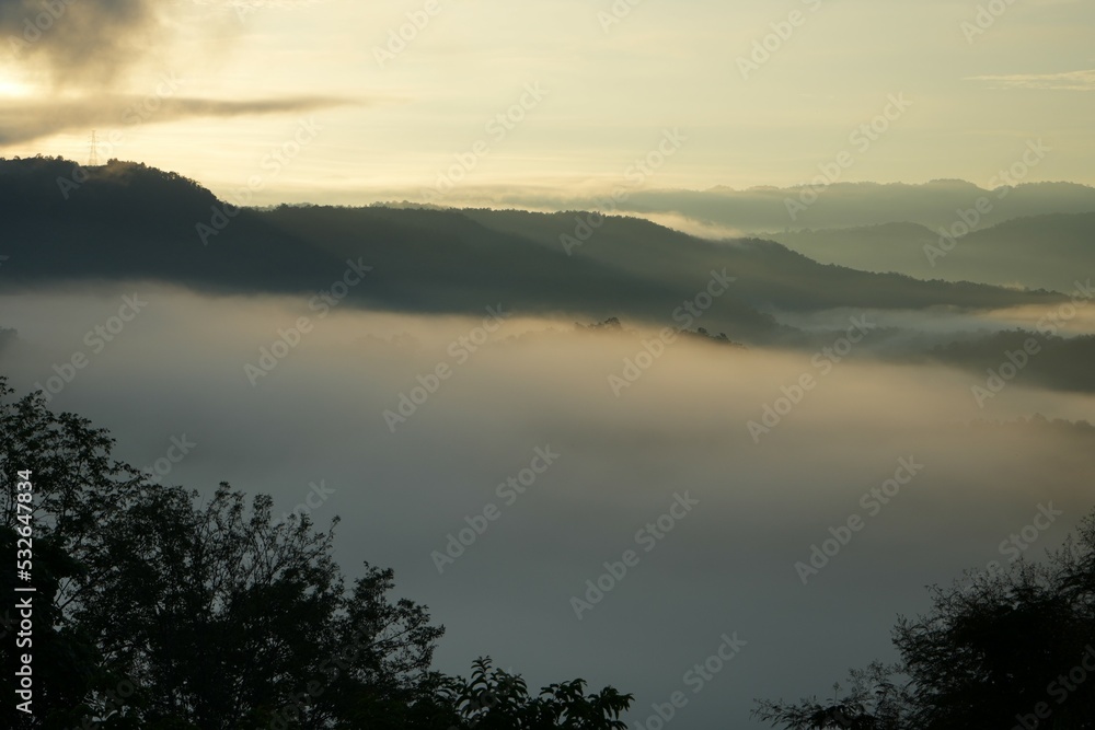 Mountains and clouds are exposed to the light of the morning sun on a high mountain.