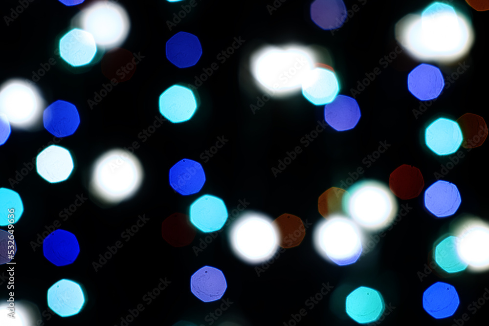 Fototapeta premium multicolored festive lights on a black background screensaver backdrop