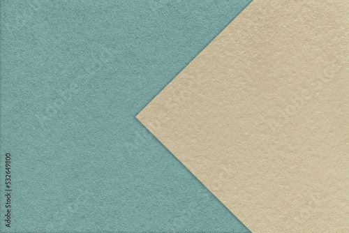 Texture of old craft blue paper background, half two colors with light beige arrow. Vintage kraft sand cardboard.