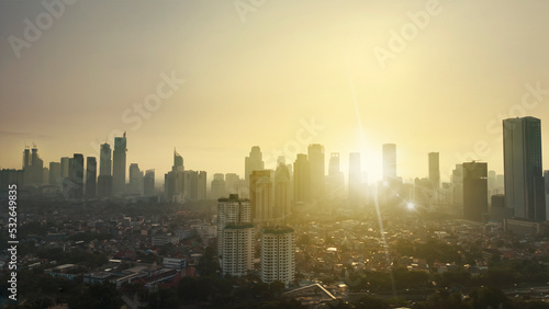 Suburban houses with skyscraper at dusk in Jakarta