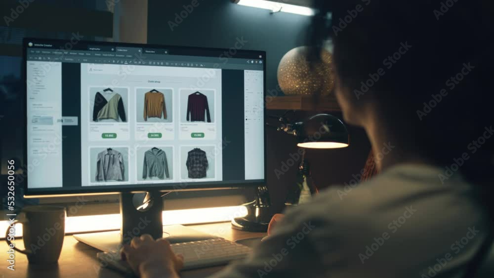 Male web designer using personal computer for creating website in professional constructor while working on project remotely at home. Freelance