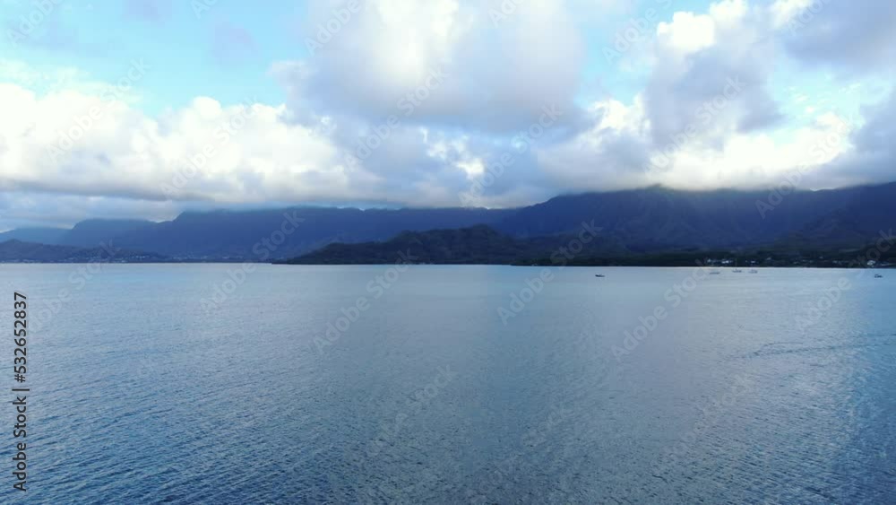 A tilt up shot of sea bay in mountains landscape. A tremendous view of Kaneohe bay on the island of Oahu captured through drone A tilt up shot of sea bay in mountains landscape. A tremendous view of Kaneohe bay on the island of Oahu captured through drone