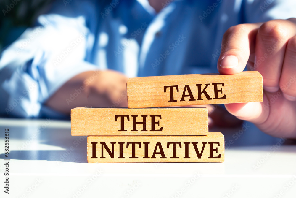 Wooden blocks with words 'Take the Initiative'. Wooden blocks with words 'Take the Initiative'.