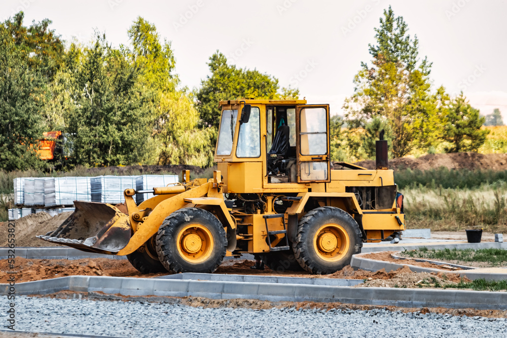 Powerful crawler bulldozer close-up at the construction site. Construction equipment for moving large volumes of soil. Modern construction machine. Road building machine. Powerful crawler bulldozer close-up at the construction site. Construction equipment for moving large volumes of soil. Modern construction machine. Road building machine.