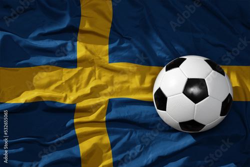 vintage football ball on the waveing national flag of sweden background. 3D illustration