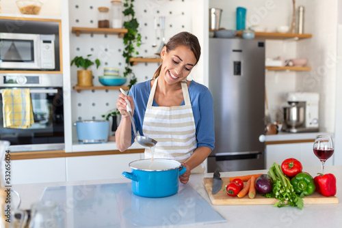 Beautiful young woman stand at modern kitchen chop vegetables prepare fresh vegetable salad for dinner or lunch, young woman cooking at home make breakfast follow healthy diet, vegetarian concept