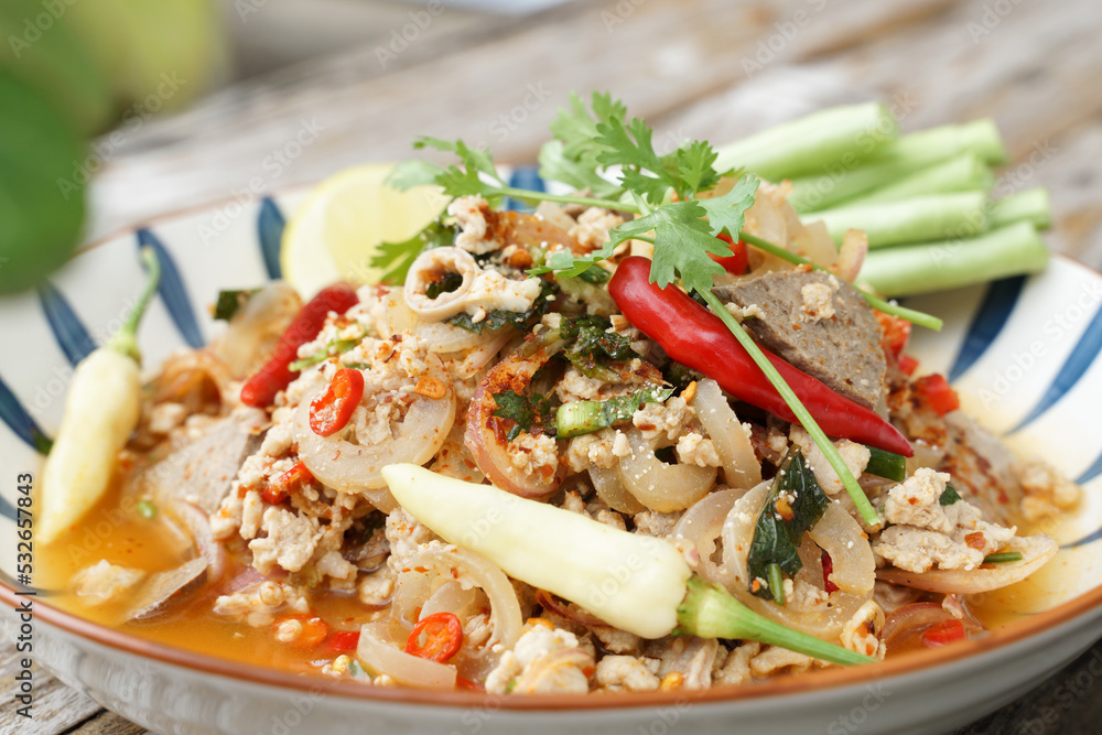 Spicy minced pork salad served with fresh vegetables Minced pork salad is a popular traditional Thai food of Thailand. Spicy Minced Pork Salad is also called Larb Moo. Spicy minced pork salad served with fresh vegetables Minced pork salad is a popular traditional Thai food of Thailand. Spicy Minced Pork Salad is also called Larb Moo.