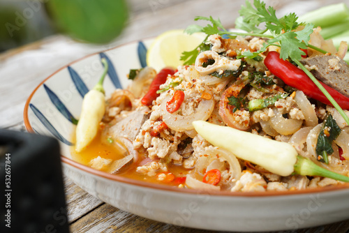 Spicy minced pork salad served with fresh vegetables Minced pork salad is a popular traditional Thai food of Thailand. Spicy Minced Pork Salad is also called Larb Moo.