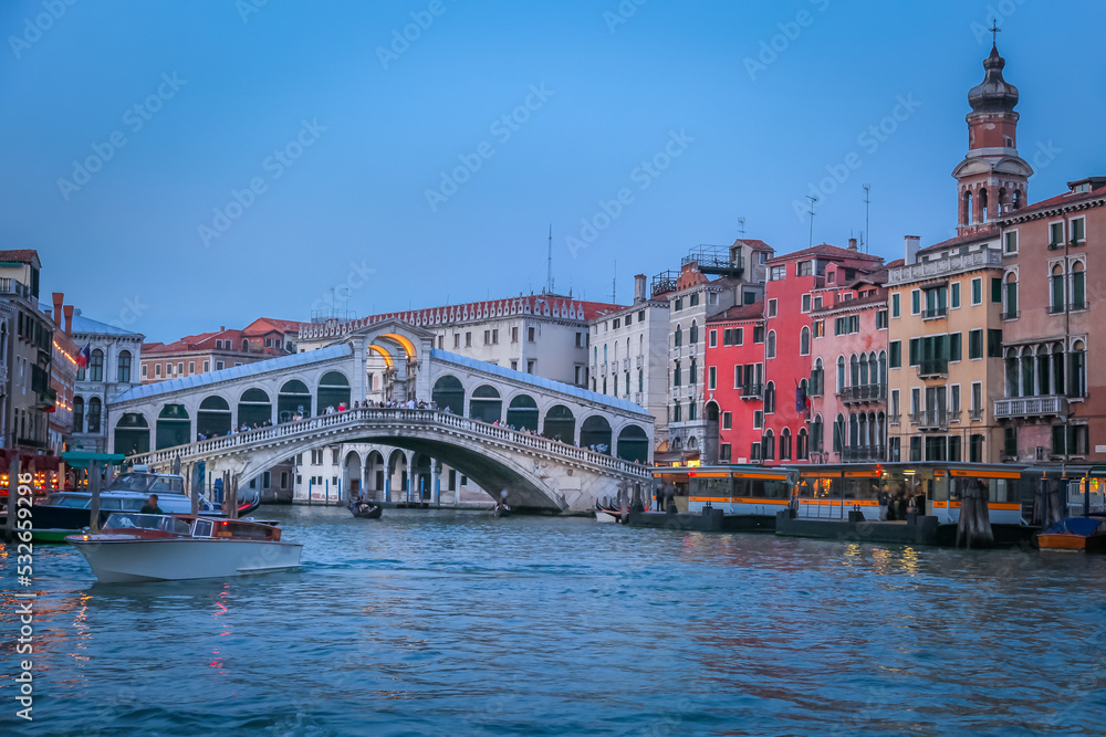 Rialto and ornate Gondolas in Grand Canal pier at sunset, Venice, Italy