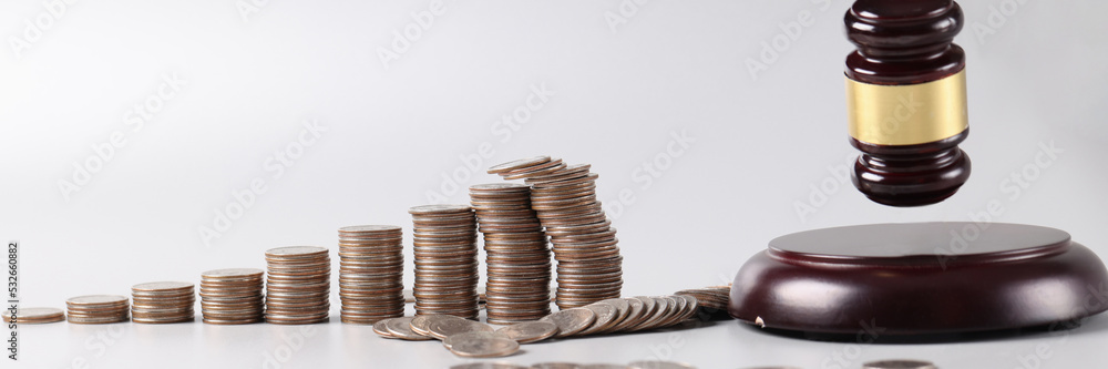 Judicial gavel and stacks of coins and financial crimes Judicial gavel and stacks of coins and financial crimes