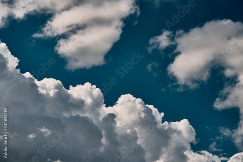 Backdrop of a white cloud in a blue summer sky. Natural background with soft clouds.