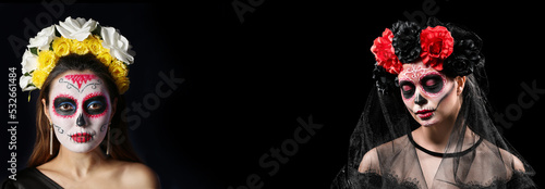 Young woman with painted skull on her face for Mexico's Day of the Dead against dark background