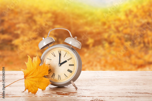 Alarm clock and autumn leaf...