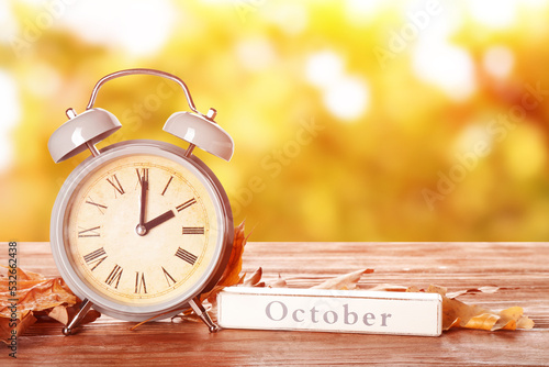 Alarm clock, word OCTOBER a...