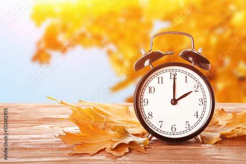 Alarm clock and autumn leav...