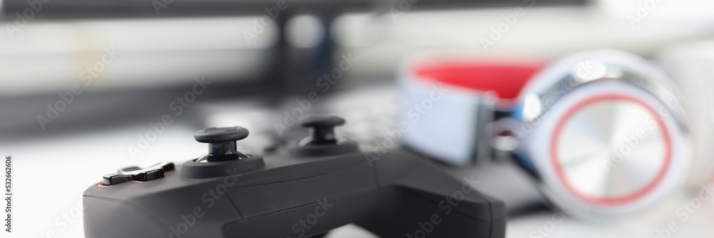 Game joystick headphones and computer monitor closeup Game joystick headphones and computer monitor closeup