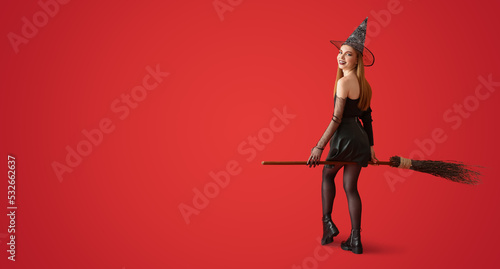 Beautiful woman with broom dressed as witch for Halloween on red background with space for text